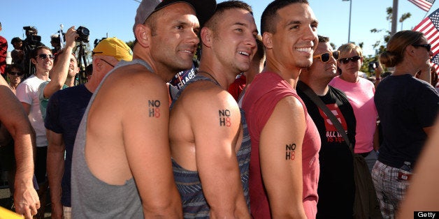 Same-sex marriage supporters Yale Scott (L), David Schulenberg (C) and Mark Martinez (R) show off their temporary tattoos reading 'NoH8' during a rally celebrating today's Supreme Court rulings regarding same-sex marriage, June 26 2013, in West Hollywood California. The US Supreme Court on Wednesday struck down the Defense of Marriage Act (DOMA), a controversial federal law that defines marriage as a union between a man and a woman and also ruled that Proposition 8, California's ban on gay marriage, could not be defended before the Supreme Court, paving the way for the resumption of gay marriages in California. AFP PHOTO / ROBYN BECK (Photo credit should read ROBYN BECK/AFP/Getty Images)