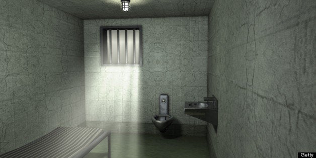 An empty jail cell in a traditional prison