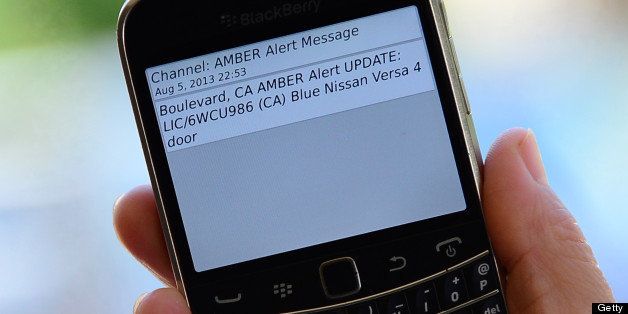 A cellphone displays the Amber Alert issued late on August 5, 2013 in Los Angeles, California, which marked the first time officials have notified the public of a statewide Amber Alert through their cellphones. The alert was in reference to James Lee DiMaggio, suspected of killing Christina Anderson, 44, and kidnapping one or both of her children: Hannah Anderson, 16, and Ethan Anderson, 8. Cellphone owners reportedly received messages automatically based on their proximity to the emergency, and not based on their phone number. The Amber Alerts sent out overnight described the vehicle DiMaggio is believed to be traveling in: a blue Nissan Versa with California license plate 6WCU986. Authorities believe the suspect may be making his way north to Canada. AFP PHOTO/Frederic J. BROWN (Photo credit should read FREDERIC J. BROWN/AFP/Getty Images)