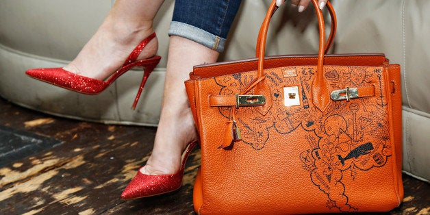 NEW YORK, NY - MAY 14: Comes With Baggage Founder Lori Levine shows off her one-of-a-kind orange Hermès Birkin at the Comes