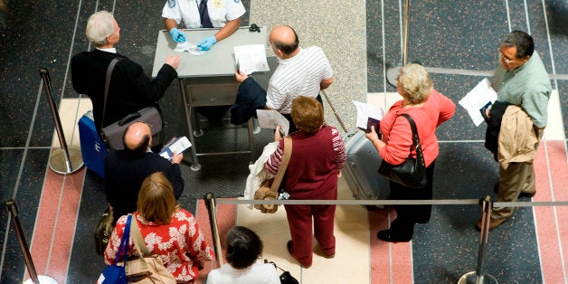 WASHINGTON - MAY 23: People wait in a TSA security line at Reagan National Airport May 23, 2008 in Washington, DC. The Memorial Day holiday weekend is experiencing the first decline in years. In addition to record gas prices causing rising airline ticket costs, travelers this summer will also face fewer flights scheduled. (Photo by Brendan Smialowski/Getty Images)