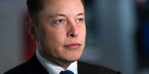 Elon Musk, billionaire, co-founder and chief executive officer of Tesla Motors Inc., poses for a photograph inside the Tesla store at Westfield Stratford City retail complex in London, U.K., on Thursday, Oct. 24, 2013. Tesla, the electric-car maker led by Musk, had its first quarterly profits this year with a boost from selling California pollution credits. Photographer: Simon Dawson/Bloomberg via Getty Images 