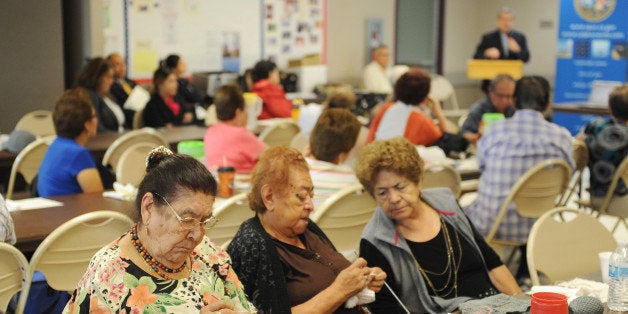 Women knit as they attend a Senior Information & Resource Fair in South Gate, California September 10, 2013 . The event included a discussion of how the Affordable Care Act, also called 'Obamacare' will impact senior citizens and what insurance plans will be available to them. With just weeks until a centerpiece of the health care reform law launches, the task of spreading the word about new health insurance marketplaces will fall to local navigators and counselors employed locally but funded by federal grant money. AFP PHOTO / Robyn Beck (Photo credit should read ROBYN BECK/AFP/Getty Images)