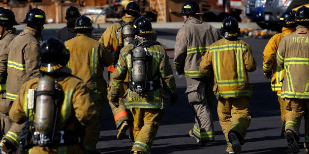 Fire academy recruits run double time across the yard while receiving rapid intervention crew (RIC) training at the El Camino Community College Fire Academy in Inglewood, California, U.S., on Saturday, Nov. 16, 2013. The U.S. Department of Labor is scheduled to release initial jobless claims on Nov. 21. Photographer: Patrick T. Fallon/Bloomberg via Getty Images