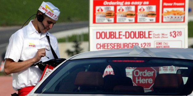 An In-N-Out Burger employee takes a drive-thru order on a wireless tablet at a restaurant in Costa Mesa, California, U.S., on Wednesday, Feb. 6, 2013. In-N-Out, with almost 280 units in five states, is valued at about $1.1 billion based on the average price-to-earnings, according to the Bloomberg Billionaires Index. Photographer: Patrick T. Fallon/Bloomberg via Getty Images