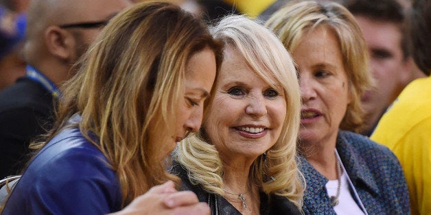 OAKLAND, CA - APRIL 27: Shelly Sterling (C), the wife of Donald Sterling owner of the Los Angeles Clippers, watches the Clippers against the Golden State Warriors in Game Four of the Western Conference Quarterfinals during the 2014 NBA Playoffs at ORACLE Arena on April 27, 2014 in Oakland, California. The players wore theirs warm up this way in protest of owner Donald Sterling's racially insensitive remarks. NOTE TO USER: User expressly acknowledges and agrees that, by downloading and or using this photograph, User is consenting to the terms and conditions of the Getty Images License Agreement. (Photo by Thearon W. Henderson/Getty Images)