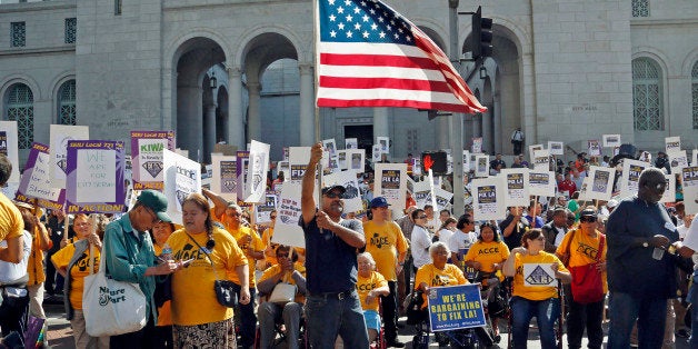 Demonstrators take part in a march and rally sponsored the Service Employees International Union in downtown Los Angeles Tuesday, Oct. 28, 2014. The Fix LA coalition, as they describe themselves, calls on city officials to establish job creation programs, institute a $15 minimum wage, place crossing guards at every school, and stop burdening taxpayers with bank foreclosure costs, organizers say. The demonstration ended with a rally at City Hall. (AP Photo/Nick Ut)