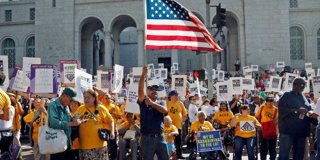 Demonstrators take part in a march and rally sponsored the Service Employees International Union in downtown Los Angeles Tuesday, Oct. 28, 2014. The Fix LA coalition, as they describe themselves, calls on city officials to establish job creation programs, institute a $15 minimum wage, place crossing guards at every school, and stop burdening taxpayers with bank foreclosure costs, organizers say. The demonstration ended with a rally at City Hall. (AP Photo/Nick Ut)