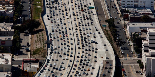 Vehicles sit in rush hour traffic on the Interstate 405 freeway in this aerial photograph taken over the Westwood neighborhood of Los Angeles, California, U.S., on Friday, July 10, 2015. The greater Los Angeles region routinely tops the list for annual traffic statistics of metropolitan areas for such measures as total congestion delays and congestion delays per peak-period traveler. Photographer: Patrick T. Fallon/Bloomberg via Getty Images