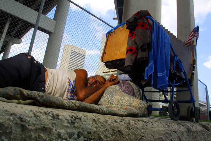 397550 01: Belede Martinez, who is homeless, sleeps November 20, 2001 on a sidewalk in Miami, Florida. Nearly one third of the city's population - 32 percent of residents - lives in poverty, a greater percentage than in any other city of 250,000 or more, the US Census survey indicates. (Photo by Joe Raedle/Getty Images)