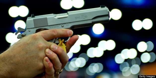 A convention goer handles a Ruger 1911 model semi-automatic pistol during the142nd annual National Rifle Association(NRA) con