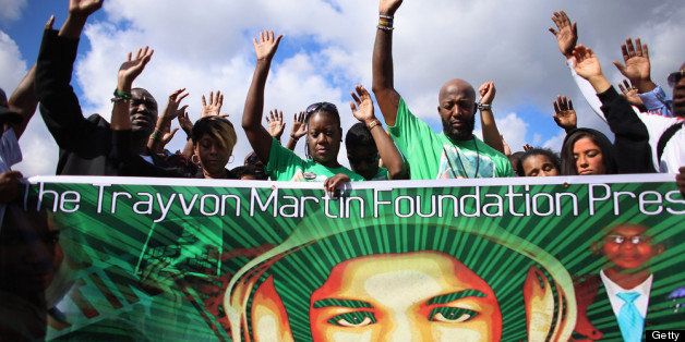 MIAMI, FL - FEBRUARY 09: Sybrina Fulton (3rd from L) and Tracy Martin (4th from L) raise their hands in prayer during the 'March for Peace' at Ives Estate Park in honor of their late son, Trayvon Martin, on February 9, 2013 in Miami, Florida. Trayvon Martin was killed by George Zimmerman on February 26, 2012 while Zimmerman was on neighborhood watch patrol in the gated community of The Retreat at Twin Lakes in Sanford, Florida. (Photo by Joe Raedle/Getty Images)