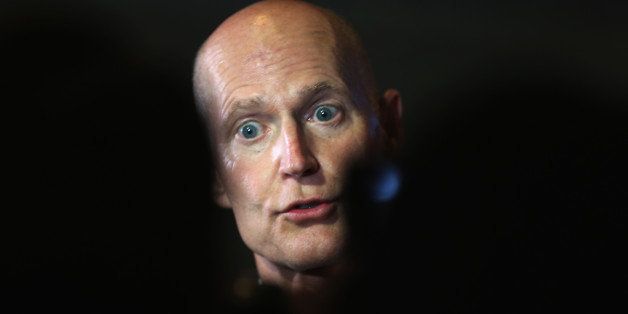 MIAMI, FL - AUGUST 20: Florida Governor Rick Scott speaks with the media after holding a Florida Cabinet at the Miami-Dade College Wolfson Campus Auditorium on August 20, 2013 in Miami, Florida. The governor released a press release yesterday indicating he has privacy concerns surrounding the Obama Administrations use of taxpayer-funded organizers called 'Navigators' to sign up Floridians on federal health exchanges. (Photo by Joe Raedle/Getty Images)