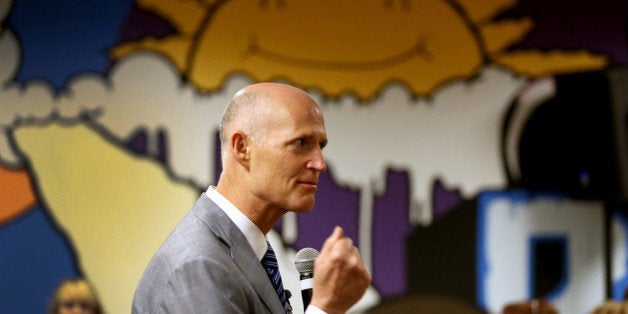 MIAMI, FL - SEPTEMBER 19: Florida Governor Rick Scott speaks during a town hall meeting with the Agency for Persons with Disabilities (APD) at the Spelios Center, one of Sunrise Groups adult day training centers, to discuss issues impacting the greater disabilities community on September 19, 2013 in Miami, Florida. The Florida Governor leads the state that has refused to set up its own health care exchange in preparation for the Affordable Care Act, which is set to begin enrollment on October 1. Republican leaders in Florida have also highlighted concerns about the navigators, federally funded workers who will help enroll people in health plans. (Photo by Joe Raedle/Getty Images)