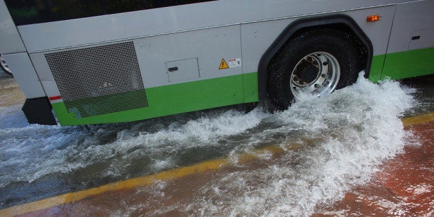 MIAMI BEACH, FL - OCTOBER 18: A public bus stirs up a wake as it drives through a flooded street near where protesters were calling on the presidential candidates to talk about their plans to fight climate change on October 18, 2012 in Miami Beach, Florida. Some of the streets on Miami Beach are flooded due to unusually high tides that the protesters felt are due to rising seas, which are connected to global warming and climate change. Published reports indicate that Florida ranks as the most vulnerable state to sea-level rise, with some 2.4 million people, 1.3 million homes and 107 cities at risk from a four-foot rise in sea levels. (Photo by Joe Raedle/Getty Images)