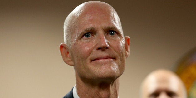 MIAMI, FL - JANUARY 14: Florida Governor Rick Scott as he introduces Carlos Lopez-Cantera as his new lieutenant governor on January 14, 2014 in Miami, Florida. Scott took 10-months to replace Jennifer Carroll, who resigned last March. Lopez-Cantera will be the states first Hispanic lieutenant governor. (Photo by Joe Raedle/Getty Images)