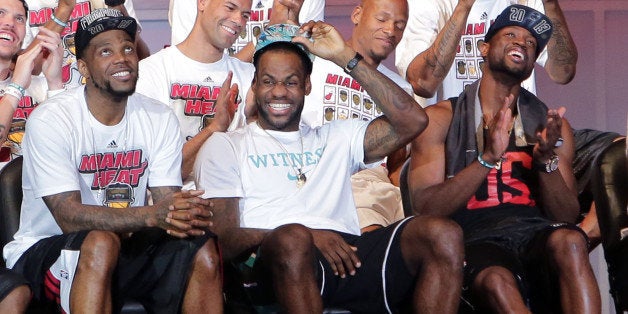 MIAMI, FL - JUNE 24: (L-R) Udonis Haslem, LeBron James and Dwyane Wade of the Miami Heat attend their NBA Championship victory rally at the AmericanAirlines Arena on June 24, 2013 in Miami, Florida. The Miami Heat defeated the San Antonio Spurs in the NBA Finals. (Photo by Alexander Tamargo/Getty Images)