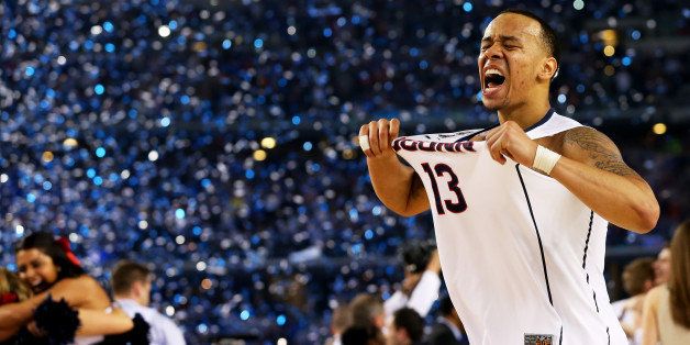 ARLINGTON, TX - APRIL 07: Shabazz Napier #13 of the Connecticut Huskies celebrates on the court after defeating the Kentucky Wildcats 60-54 in the NCAA Men's Final Four Championship at AT&T Stadium on April 7, 2014 in Arlington, Texas. (Photo by Ronald Martinez/Getty Images)