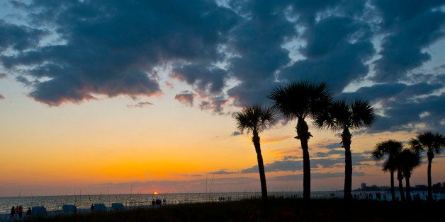 Florida, Siesta Key, Crescent Beach, Palms frame a cloudy dying sunset. (Photo By: Education Images/UIG via Getty Images)