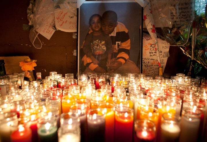 NEW YORK, NY - MARCH 13: A photograph of Kimani Gray and his younger sister is illuminated by candles at a memorial in his ho