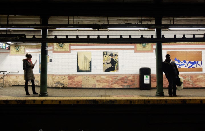 NEW YORK - FEBRUARY 12: Riders stand in front of reproductions of famous artwork in the Atlantic Avenue subway station February 12, 2009 in the Brooklyn borough of New York City. The Museum of Modern Art has installed 58 reproductions of pieces from their permanent collection, by artists including Picasso, Matisse, and Hopper, for the underground promotional campaign which runs through March 15th. (Photo by Mario Tama/Getty Images)