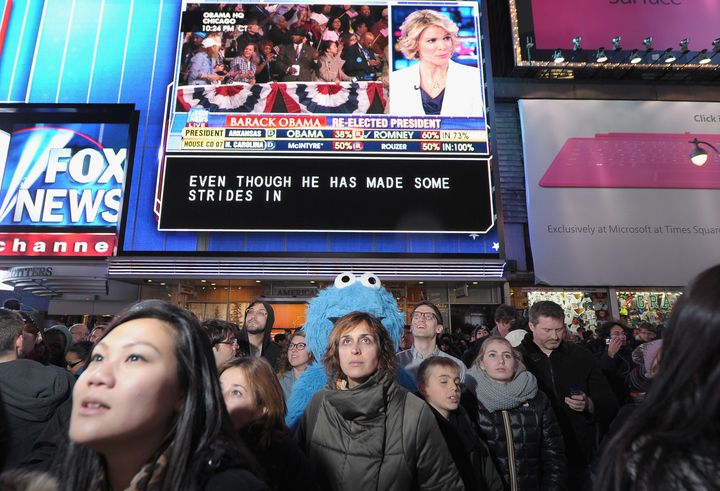 NEW YORK, NY - NOVEMBER 06: Cookie Monster and spectators come out in celebration of the 2012 Presidential Election night in Times Square on November 6, 2012 in New York City. (Photo by Michael Loccisano/Getty Images)