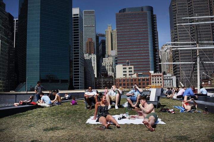 NEW YORK, NY - APRIL 09: People relax along the East River in lower Manhattan during warm weather on April 9, 2013 in New York City. For the first time since October, temperatures are expected to rise above 70 degrees this week in New York and surrounding areas. (Photo by Spencer Platt/Getty Images)