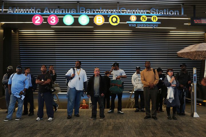 NEW YORK, NY - SEPTEMBER 28: People stand in front of the subway station at the new Barclays Center on opening night, was to feature recording artist Jay-Z on September 28, 2012 in the Brooklyn borough of New York City. Dozens of protesters and curious onlookers converged on the new arena which caused debate and controversy when it was originally proposed nine years ago. The $1 billion arena will bring a professional sports team, the Brooklyn Nets, back to Brooklyn for the first time in more than a half-century. (Photo by Spencer Platt/Getty Images)