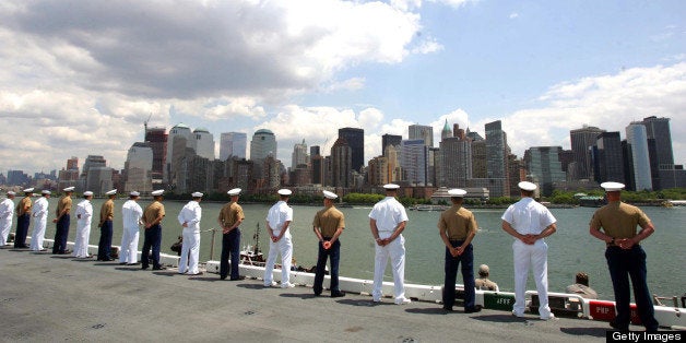 UNITED STATES - MAY 22: Sailors and Marines aboard the USS Kearsarge stand at attention on the rails as they enter New York