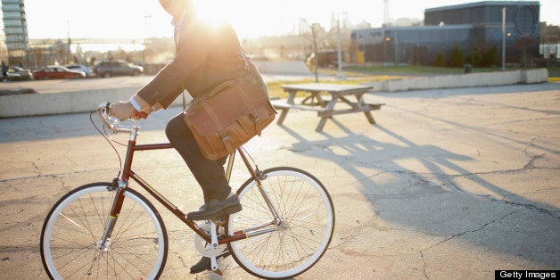 Man riding bicycle on city street