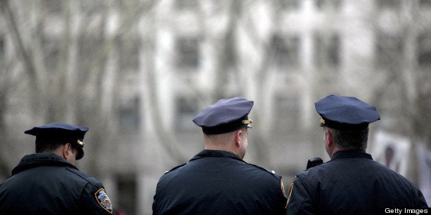 NEW YORK, NY - MARCH 18: New York CIty Police officers stand near a demonstration against the city's 'stop and frisk' searches in lower Manhattan near Federal Court March 18, 2013 in New York City. Hearings in a federal lawsuit filed by four black men against the city police department's 'stop and frisk' searches starts today in Manhattan Federal Court. (Photo by Allison Joyce/Getty Images)