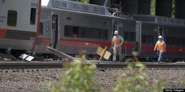 FAIRFIELD, CT - MAY 18: Connecticut state investigators examines the scene of a Metro North train collision on May 18, 2013 in Fairfield, Connecticut. Two New Haven Line Metro North commuter trains collided on Friday, May 17 near Bridgeport, CT, injuring as many as 70 people. (Photo by Michael Graae/Getty Images)