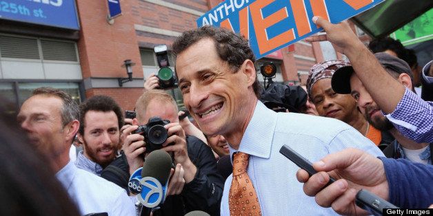NEW YORK, NY - MAY 23: Anthony Weiner (C) smiles while courting voters outside a Harlem subway station a day after announcing he will enter the New York mayoral race on May 23, 2013 in New York City. Weiner is joining the Democratic race to succeed three-term Mayor Michael Bloomberg after he was forced to resign from Congress in 2011 following the revelation of sexually explicit online behavior. (Photo by Mario Tama/Getty Images)