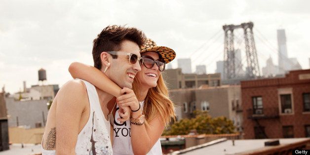 Young Couple Hugging On City Rooftop