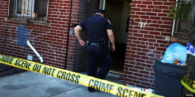 NEW YORK, NY - JUNE 04: Police stand near the scene of a murder on June 4, 2013 in the Brooklyn borough of New York City. While shootings in New York City are down, seven people were killed and more than two dozen were shot last weekend, and officials have warned that a shrinking police force could mean a violent summer ahead. In response the New York Police Department (NYPD) has set up stationary observation towers, added patrols and put additional plainclothes officers in high crime neighborhoods. (Photo by Spencer Platt/Getty Images)