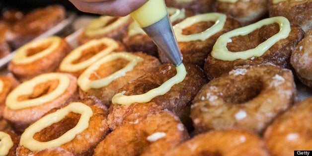 NEW YORK, NY - JUNE 10: Chef Dominique Ansel prepares a tray of croissant-doughnut hybrids, known as the 'cronut', at Dominique Ansel Bakery on June 10, 2013 in New York City. The bakery makes 200-250 of the cronuts daily, which have been in hot demand since they were introduced in May. (Photo by Andrew Burton/Getty Images)