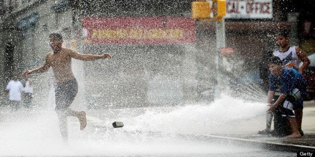 NEW YORK, NY - JUNE 09: Children play in water sprayed from a fire hydrant on June 9, 2011 in the Bronx borough of New York City. An early summer heat wave has hit the city with temperatures forecast to hit in the high nineties this afternoon. (Photo by Mario Tama/Getty Images)