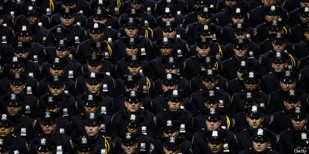 NEW YORK, NY - JULY 02: New York City Police Academy cadets attend their graduation ceremony at the Barclays Center on July 2, 2013 in the Brooklyn borough of New York City. The New York Police Department (NYPD) has more than 37,000 officers; 781 cadets graduated today. (Photo by Andrew Burton/Getty Images)