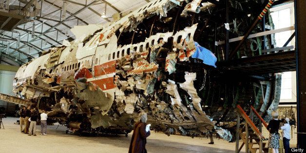 ASHBURN, VA - MAY 4: Members of the press examine a 93-foot section of the TWA Flight 800 fuselage that sits inside a state-of-the-art training facility of the new NTSB Academy May 4, 2004 in Ashburn, Virginia. The reconstructed fuselage of TWA Flight 800 which exploded over the Atlantic will be used as a teaching tool for air crash investigators. (Photo by Mark Wilson/Getty Images)