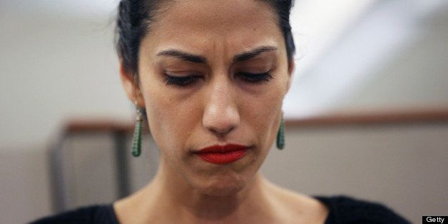 NEW YORK, NY - JULY 23: Huma Abedin, wife of Anthony Weiner, a leading candidate for New York City mayor, listens as her husband speaks at a press conference on July 23, 2013 in New York City. Weiner addressed news of new allegations that he engaged in lewd online conversations with a woman after he resigned from Congress for similar previous incidents. (Photo by John Moore/Getty Images)