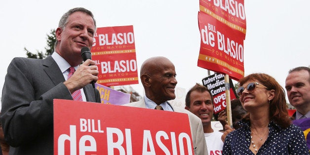 NEW YORK, NY - AUGUST 19: Democratic candidate for Mayor and Public Advocate Bill de Blasio (L) speaks as actor, singer and supporter Harry Belafonte (C) and actress Susan Sarandon (R) look on at a 'Hospitals Not Condos' rally in the West Village on August 19, 2013 in New York City. De Blasio called for quality health care for all New Yorkers and for the end of shuttering city hospitals. (Photo by Mario Tama/Getty Images)