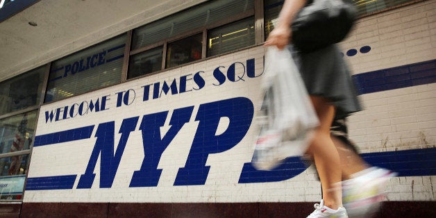 NEW YORK, NY - AUGUST 12: A woman walks by a New York Police Department (NYPD) outpost in Times Square on August 12, 2013 in New York City. The controversial policy employed by the NYPD in high crime neighborhoods known as stop and frisk, has been given a severe rebuke by a federal judge on Monday. U.S. District Court Judge Shira Scheindlin has appointed an independent monitor to oversee changes to the NYPD's stop and frisk tactic's after finding that it intentionally discriminates based on race. Both New York City Mayor Michael Bloomberg and New York City Police Commissioner Raymond Kelly. (Photo by Spencer Platt/Getty Images)