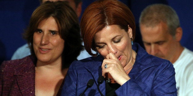 NEW YORK, NY - SEPTEMBER 10: New York City Council Speaker Christine Quinn speaks next to her wife Kim Catullo (L) during her concession speech in the New York Democratic mayoral primary elections on September 10, 2013 in New York City. Quinn, who lead early in the polls and who was endorsed by all of New York's major newspapers, saw her lead slip away in the final weeks of the campaign. Quinn would have been the first woman and lesbian to hold the job of mayor. (Photo by Spencer Platt/Getty Images)