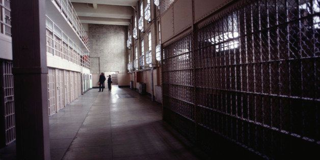 Corridor in Alcatraz prison, two people in background, San Francisco, California, USA