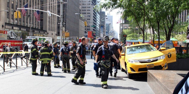 Firefighters, Dr. Oz and bystanders rushed to tourist Sian Green struck by out-of-control taxi cab on Sixth Ave. and W. 49th St. Bike messenger Kenneth Olivo said cabbie lost contol after hitting his bike. (Photo By: Marcus Santos/NY Daily News via Getty Images)