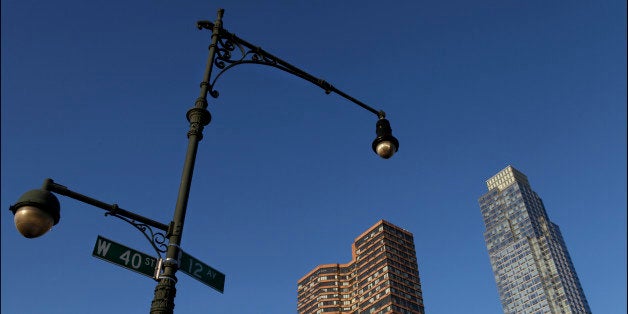 View of a street lamp and sign at 12 Avenue (aka the West Side or Lincoln Highway) and West 40th, Midtown Manhattan, New York, New York, May 14, 2013. Several residential towers (at 42nd Street, between 11th and 12th avenues) are visible in the background. (Photo by Oliver Morris/Getty Images)