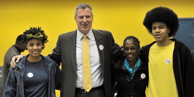 New York City Democratic mayoral candidate Bill de Blasio (2nd L) with his wife Chirlane McCray (2nd R), daughter Chiara (L) and son Dante (R) after voting at the Park Slope Branch Public Library in the Brooklyn borough of New York November 5, 2013. AFP PHOTO/Stan HONDA (Photo credit should read STAN HONDA/AFP/Getty Images)