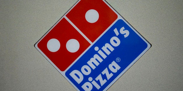 A Domino's Pizza logo hangs inside a franchise on 89th Street in New York, U.S., on Wednesday, Jan. 13, 2010. Domino's Pizza Inc., the second-largest U.S. pizza maker, said Internet orders make up the fastest-growing part of its business, accounting for as much as 30 percent of sales in some markets. Photographer: Daniel Acker/Bloomberg via Getty Images