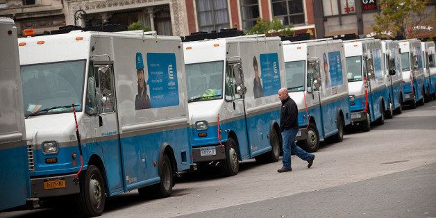 NEW YORK, NY - OCTOBER 28: A man walks past Con Edison trucks lined up in Union Square in preparation for Hurricane Sandy damage on October 28, 2012 in New York City. Sandy, which has already claimed over 50 lives in the Caribbean, is predicted to bring heavy winds and floodwaters as the mid-atlantic region prepares for the damage. (Photo by Andrew Burton/Getty Images)
