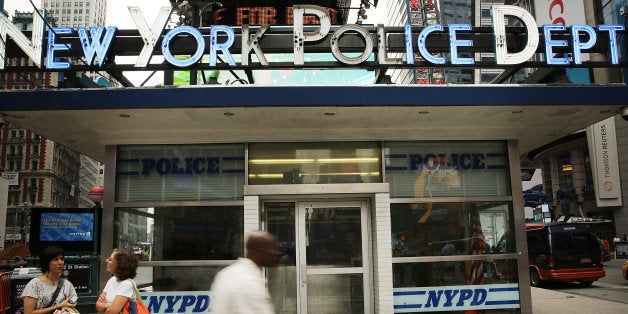 NEW YORK, NY - AUGUST 12: People walk by a New York Police Department (NYPD) outpost in Times Square on August 12, 2013 in New York City. The controversial policy employed by the NYPD in high crime neighborhoods known as stop and frisk has been given a severe rebuke by a federal judge on Monday. U.S. District Court Judge Shira Scheindlin has appointed an independent monitor to oversee changes to the NYPD's stop and frisk tactic's after finding that it intentionally discriminates based on race. Both New York Mayor Michael Bloomberg and New York City Police Commissioner Raymond Kelly. (Photo by Spencer Platt/Getty Images)